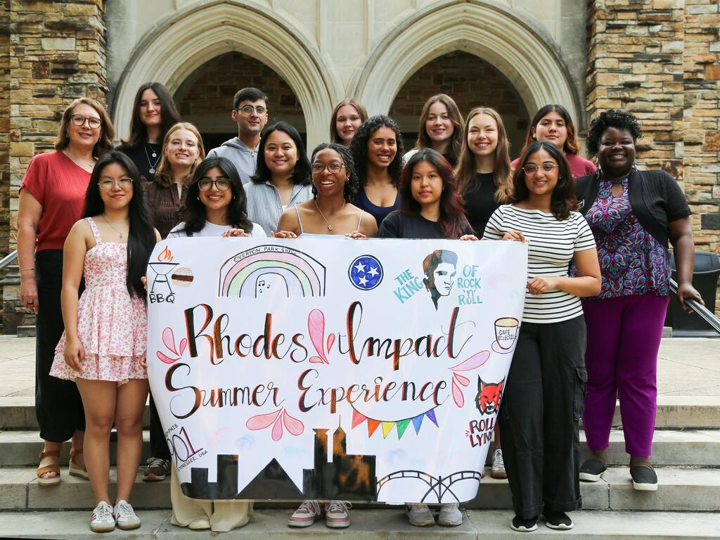 group image Rhodes College summer service students holding a sign 