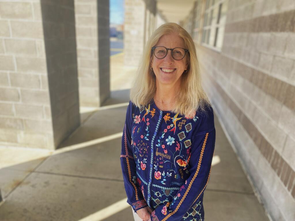 Sally Jones Heinz, smiling standing outside of a building