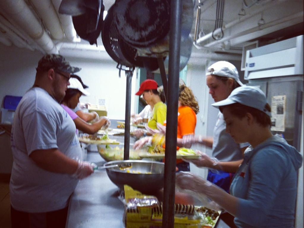 Photo of students working in the soup kitchen at St. John's Methodist Church.