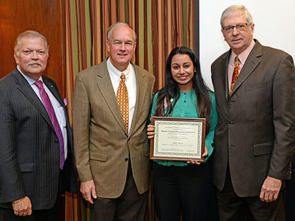 Adiha Khan is pictured with (from left) Dr. Franklin García-Godoy of UTHSC Dr. Patrick Yancey of the Hinman Dental Society and Dr.Timothy Hottel of UTHSC.