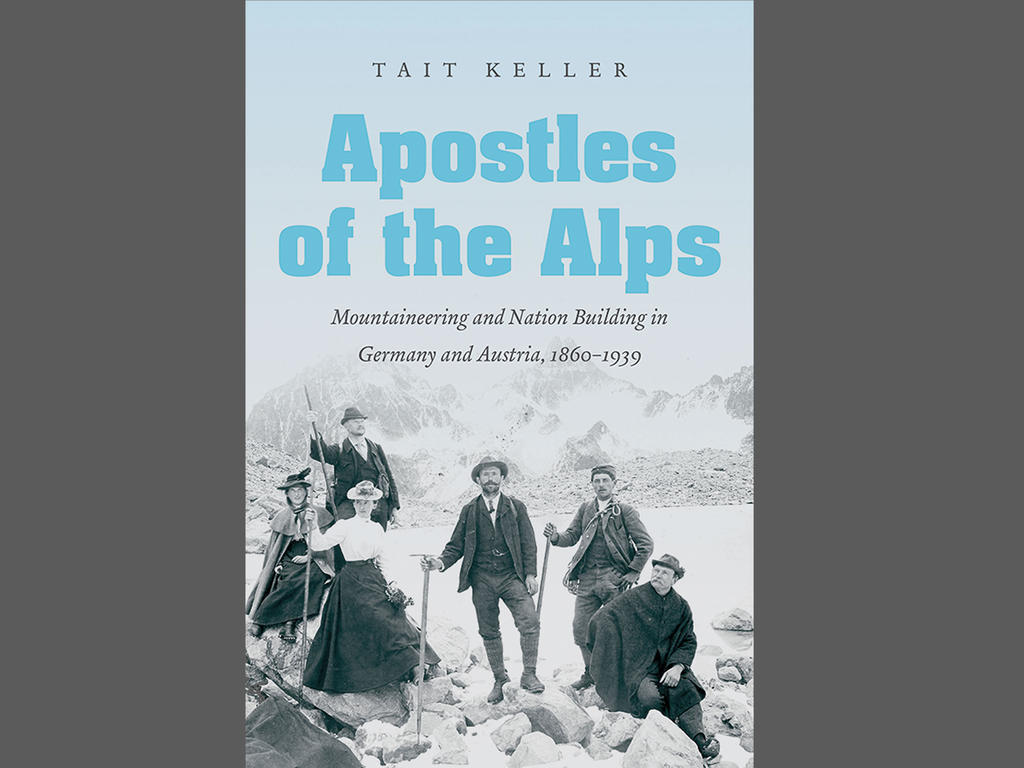 the blue front cover of the book being described in the article with an image of male and female mountaineers