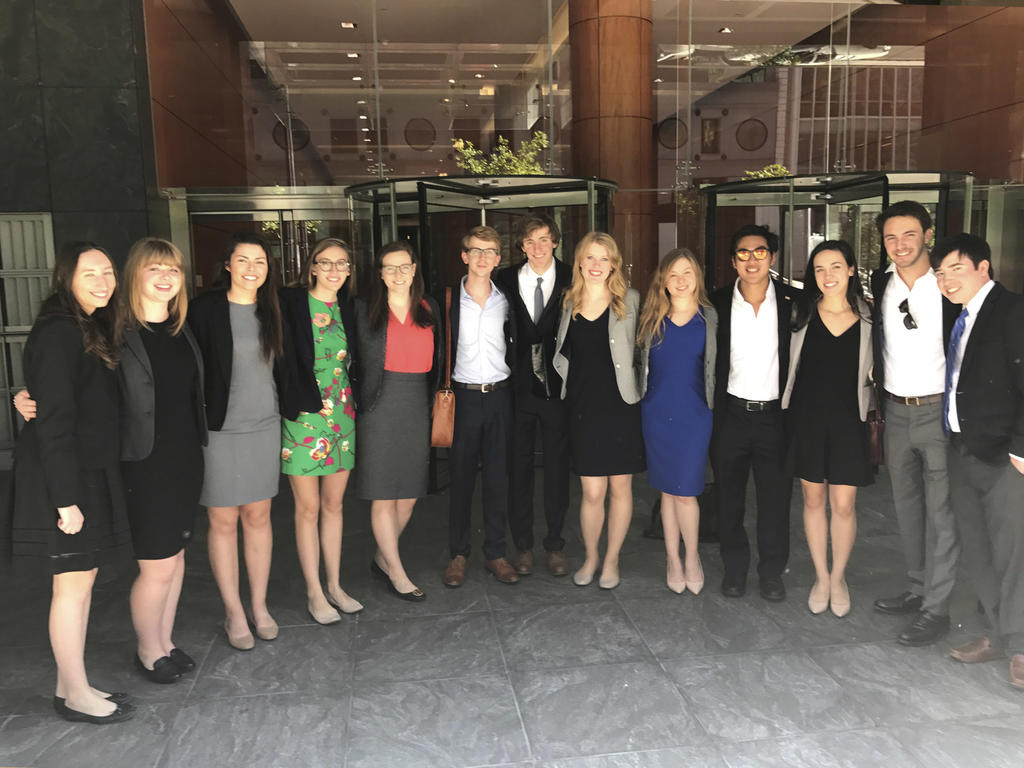 A group of diverse college students in professional business attire