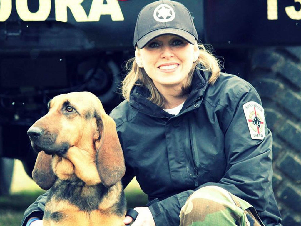 a young female and her bloodhound dog