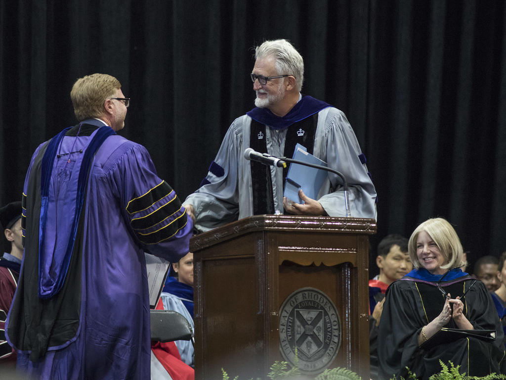 Professors in academic robes at podium at Opening Convocation ceremony