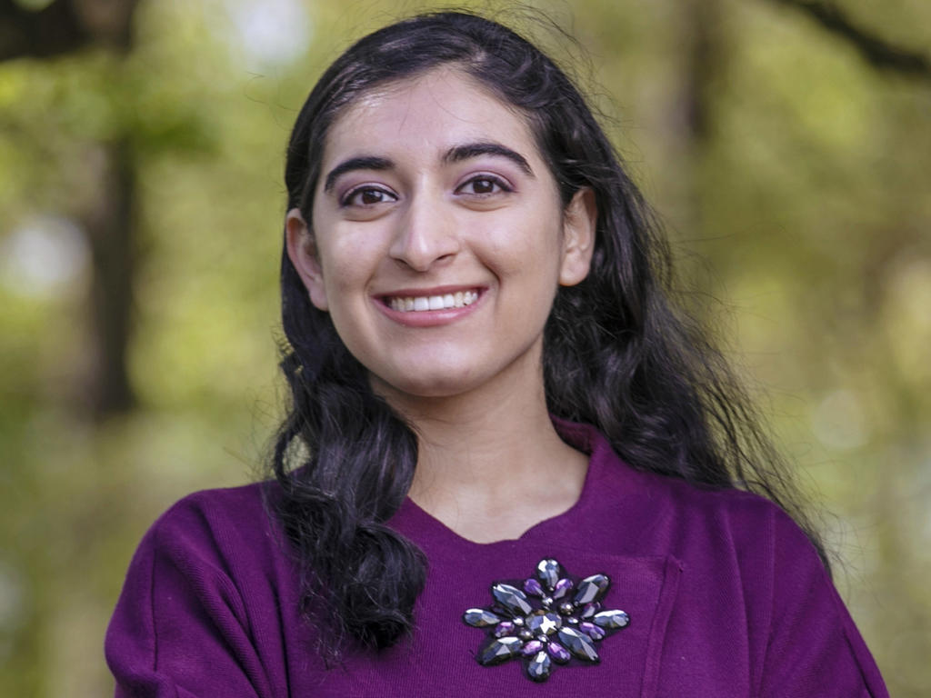 A young Indian woman looks straight into the camera