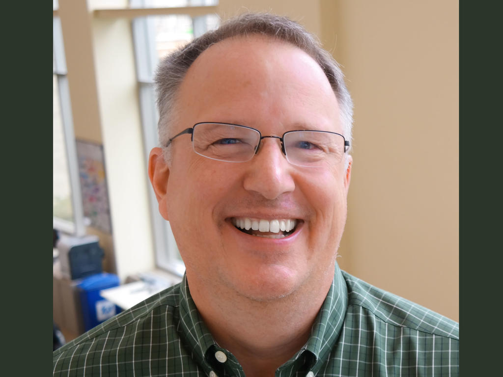 a closeup of middle aged white male smiling