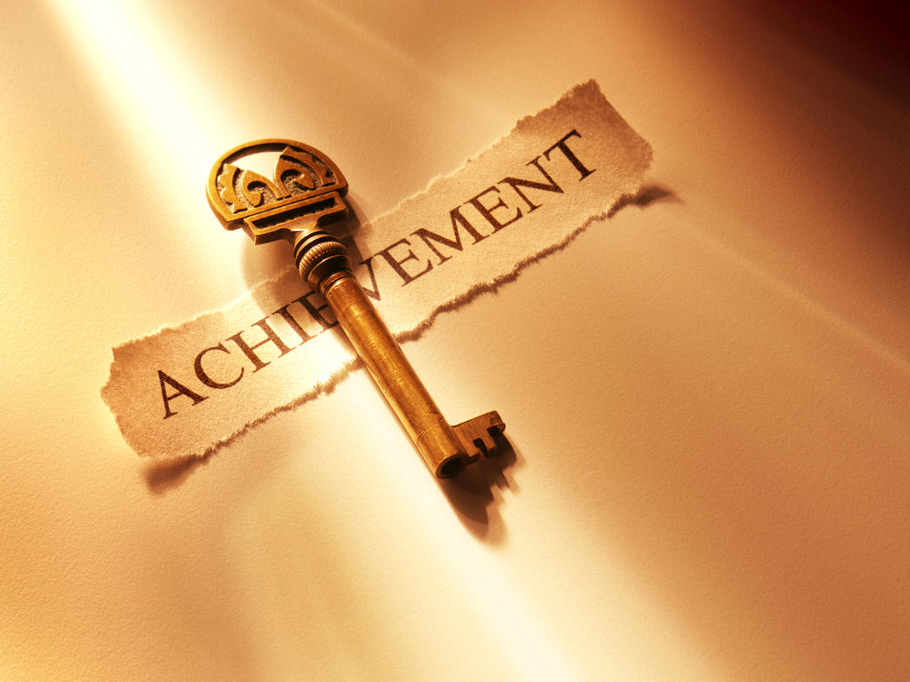 a golden key with the text "Achievement" on a piece of paper below the key, all laying on a well-lit golden surface