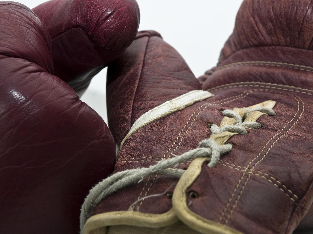 boxing gloves on a white surface 