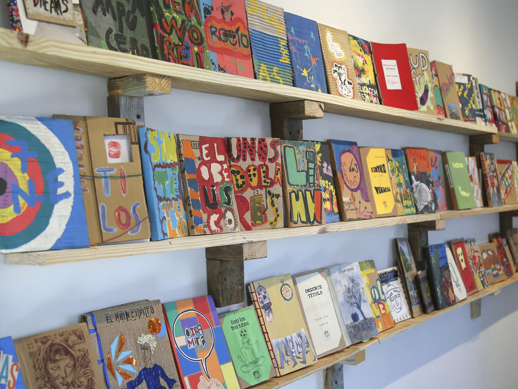 various shelves of books and blocks of colorful art