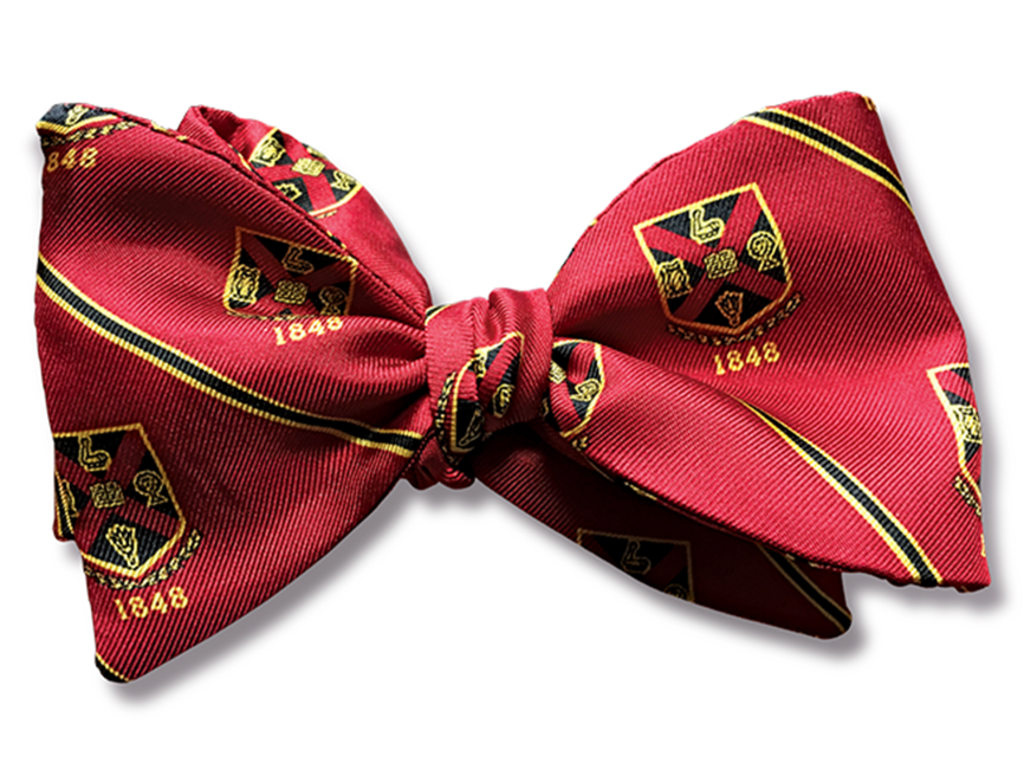 a red bow tie with the Rhodes College crest patterned throughout