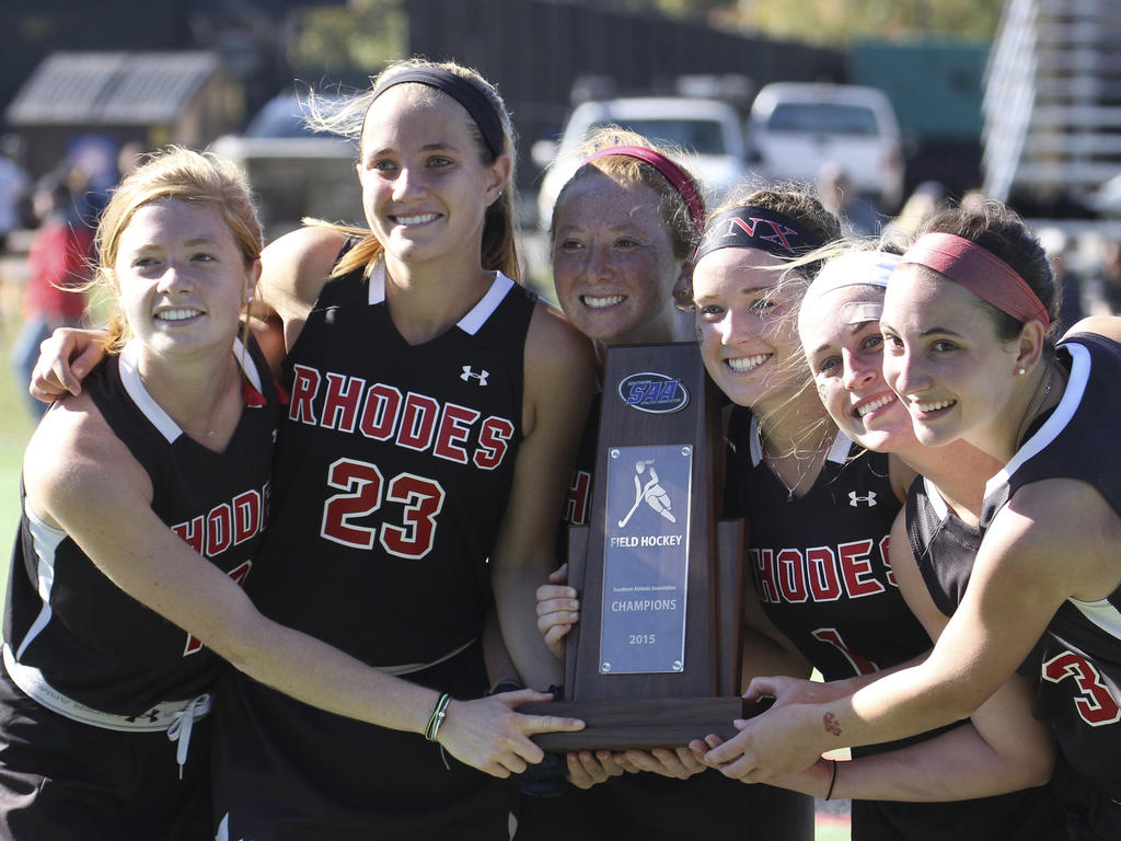 young women proudly holding their sports trophy 