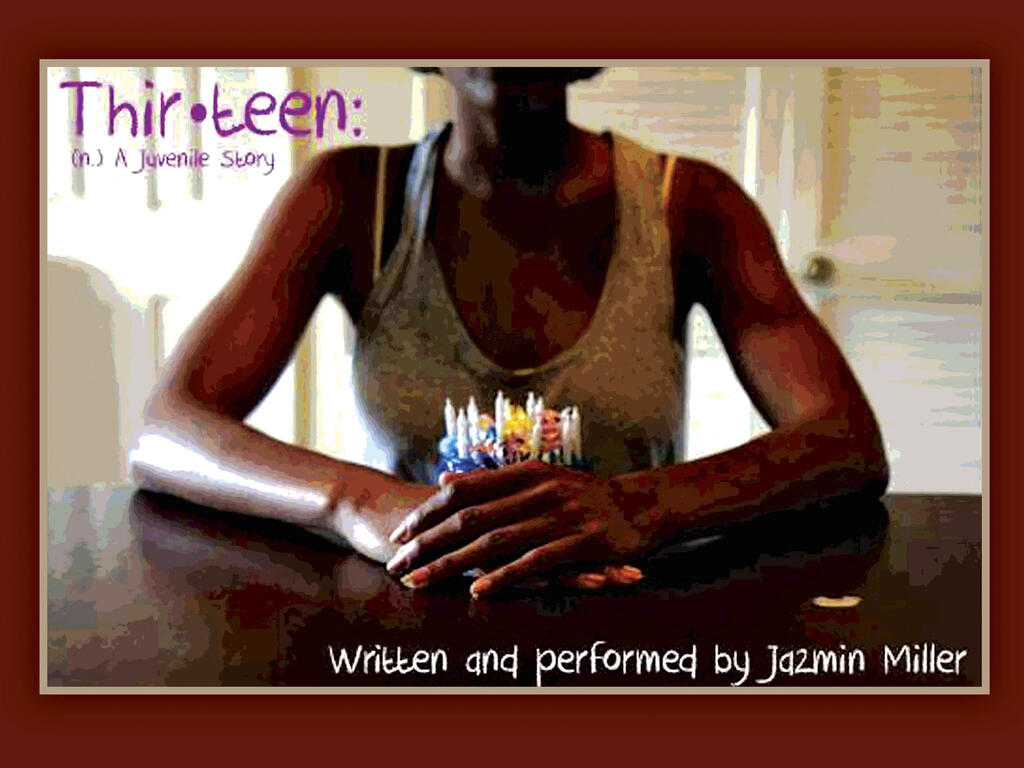 An image of an African American woman's arms holding a small blue birthday cake with candles in it