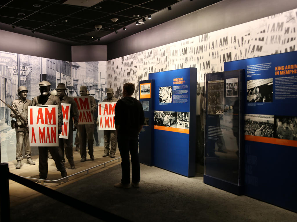 the back of a student looking at the "I am a man" exhibit